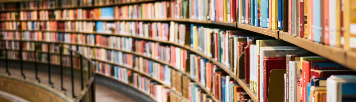 A long row of bookshelves filled with colorful books.