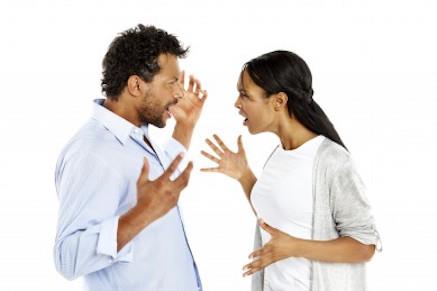 An attractive African-American couple arguing.