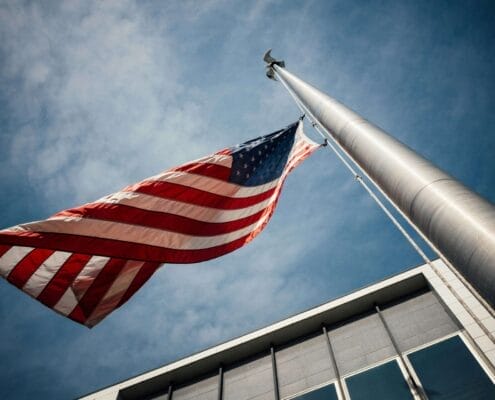 Political Division can be healed. The American Flag at half-mast outside of a building.