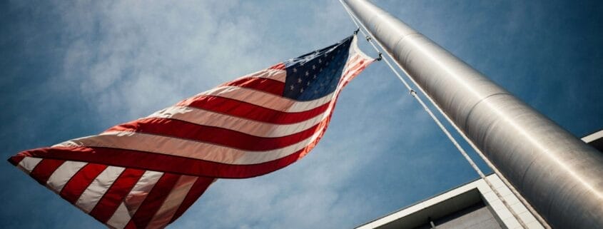 Political Division can be healed. The American Flag at half-mast outside of a building.