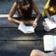 Learning disability can be debilitating academically and socially, especially for young people. A picnic table with 3 people studying.