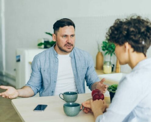 A frustrated man arguing with his spouse.