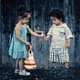 little girl gives a little boy a gift. Friendship counseling austin tx